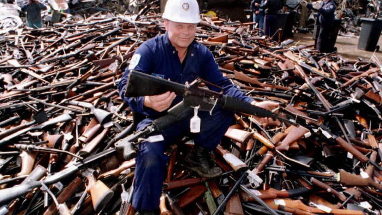 A security official holds an armalite rifle similar to the one used in the Port Arthur massacre, handed in for scrap in the gun amnesty