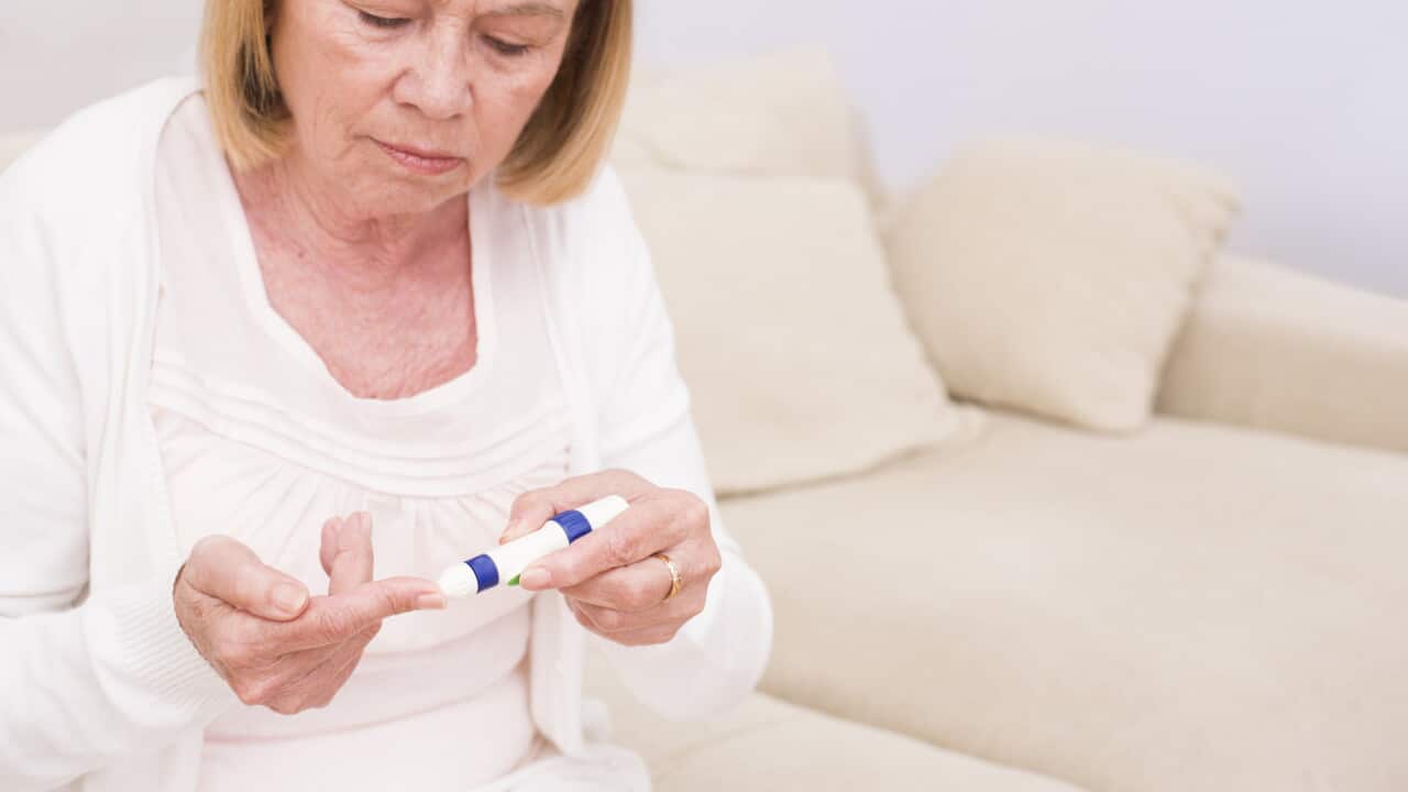 Woman testing glucose