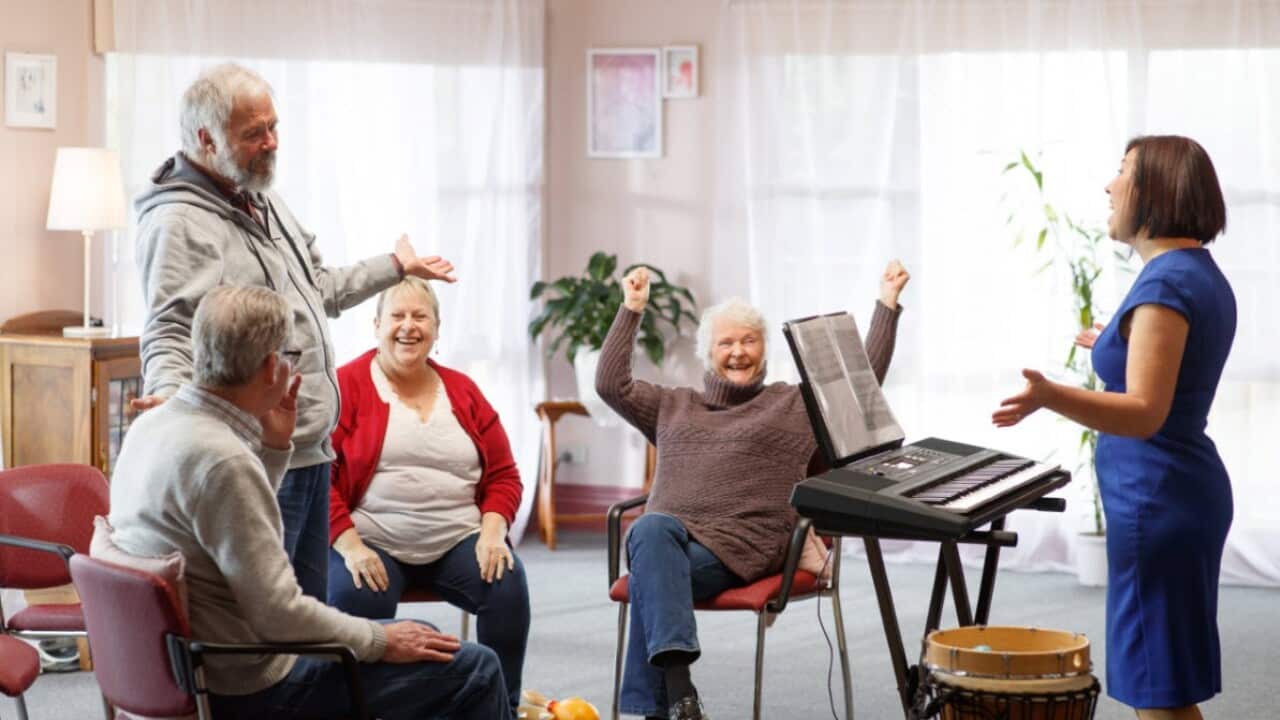 Professor Felicity Baker (R) runs a music therapy session to people living with dementia