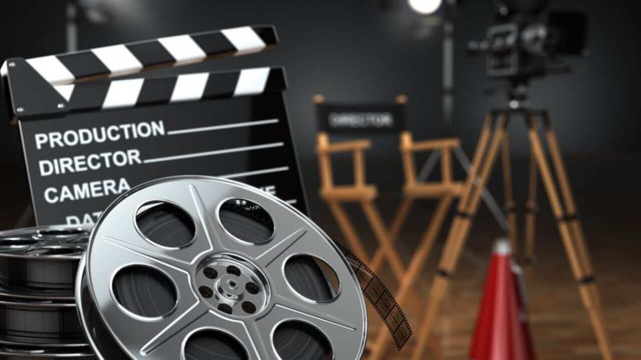 Video, movie, cinema concept. Retro camera, reels, clapperboard