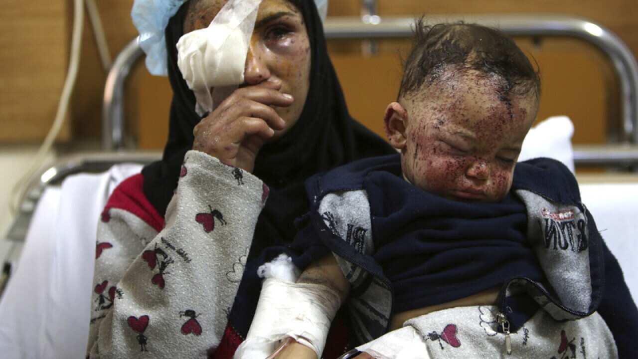 Ghadeer Mortada, 18, holds her one year old boy Mohammed in hospital