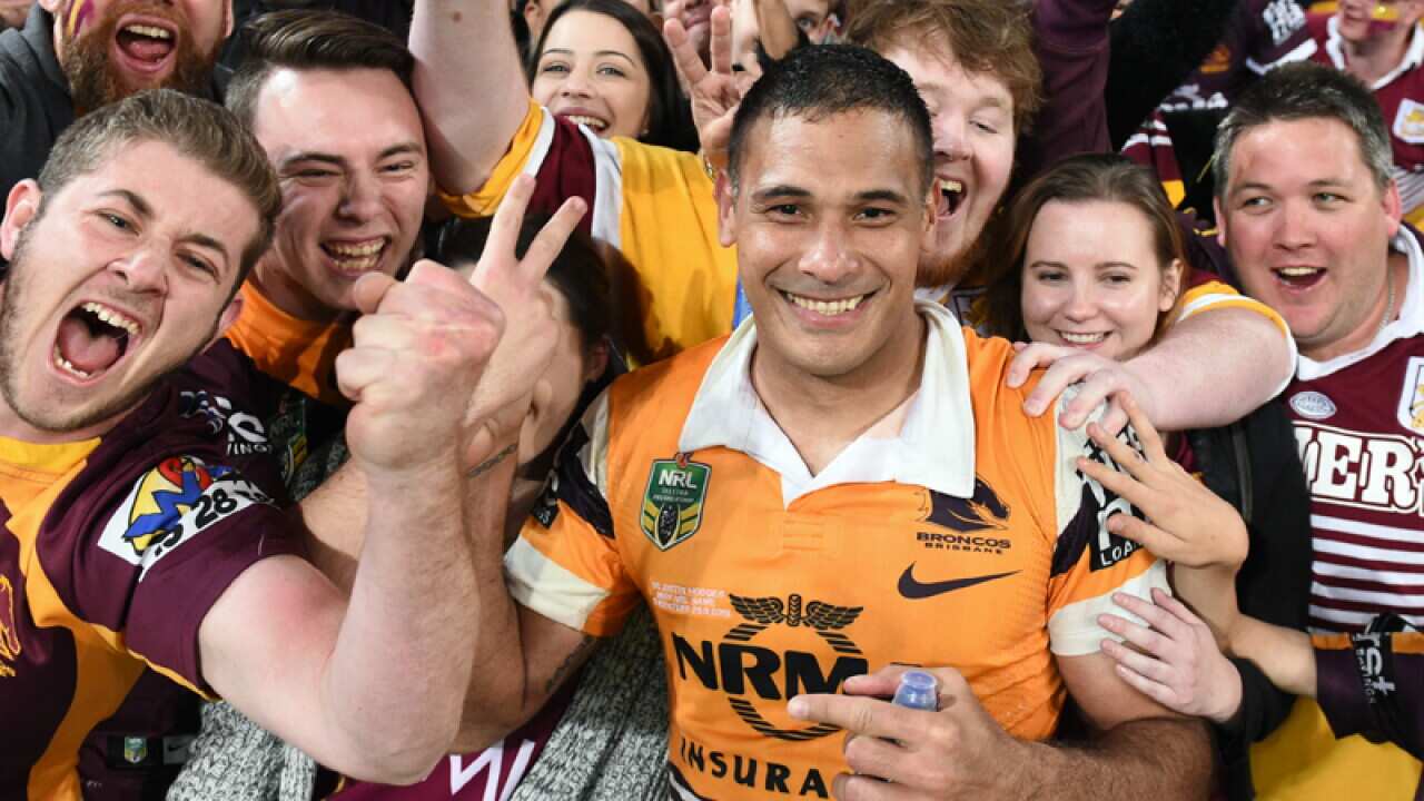 Broncos player Justin Hodges celebrates with fans