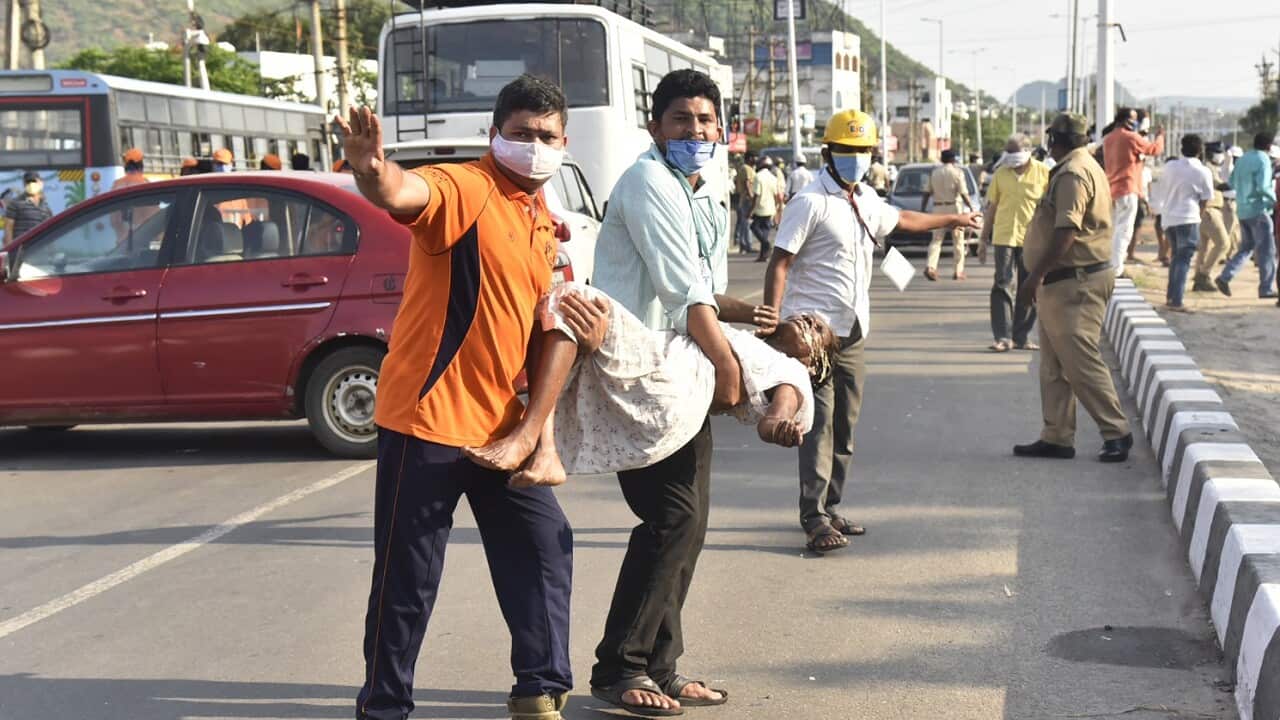 People carry a woman affected by a chemical gas leak in Vishakhapatnam, India, Thursday, May 7, 2020. Chemical gas leaked from an industrial plant in southern India early Thursday, leaving people struggling to breathe and collapsing in the streets as they