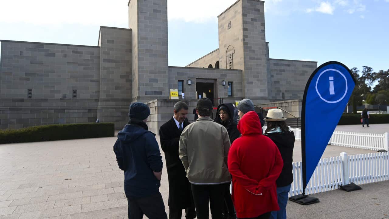 Tourists line up to enter the Australian War Memorial on the day of re-opening of the War Memorial in Canberra