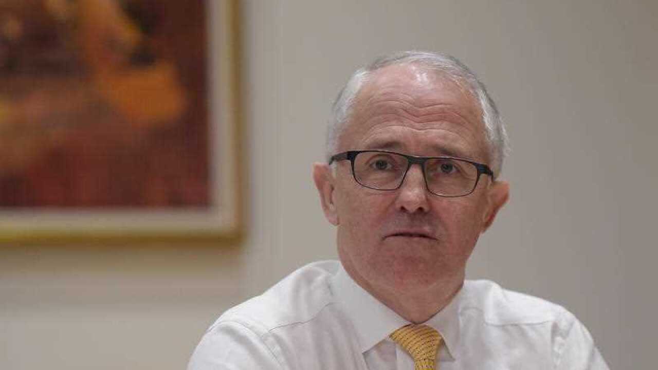 Australian Prime Minister Malcolm Turnbull speaks to members of his ministerial economic team during a meeting at Parliament House in Canberra, Wednesday, Sept. 30, 2015. (AAP Image/Lukas Coch) NO ARCHIVING