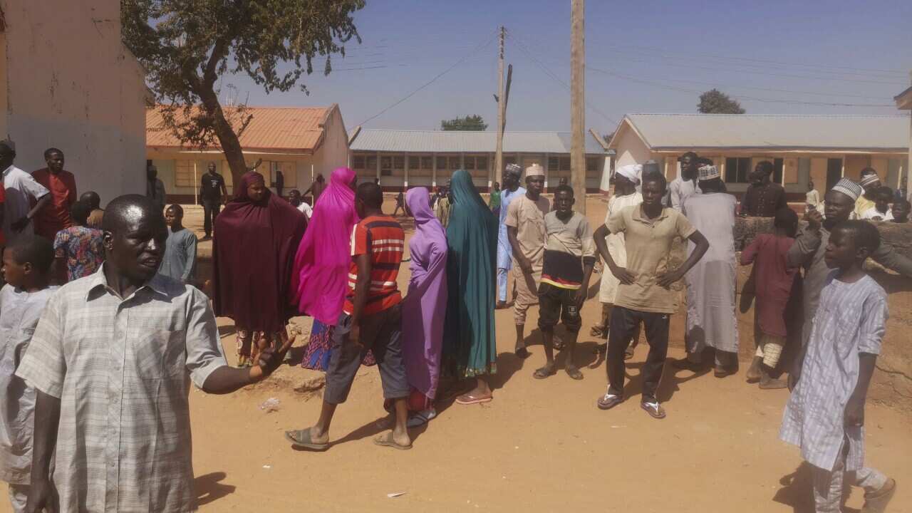 People gathered outside the Government Science Secondary School in Kankara, Nigeria Saturday, 12 December, 2020.