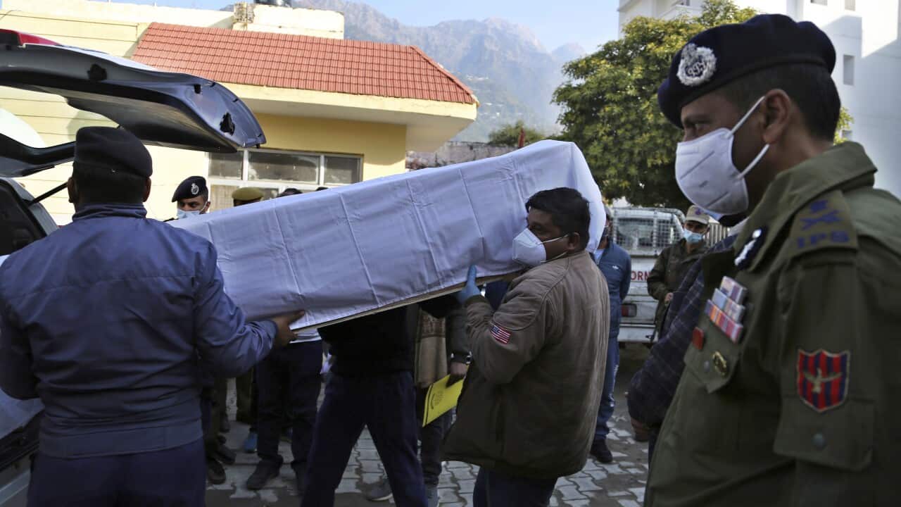 Health workers carry a coffin of one of the victims of the stampede