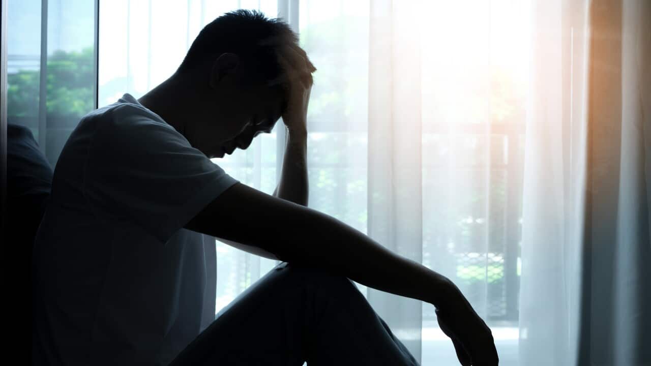 The man sitting in the corner of the room has emotional and mental problems He has depression and stress from society and work. medical concept.