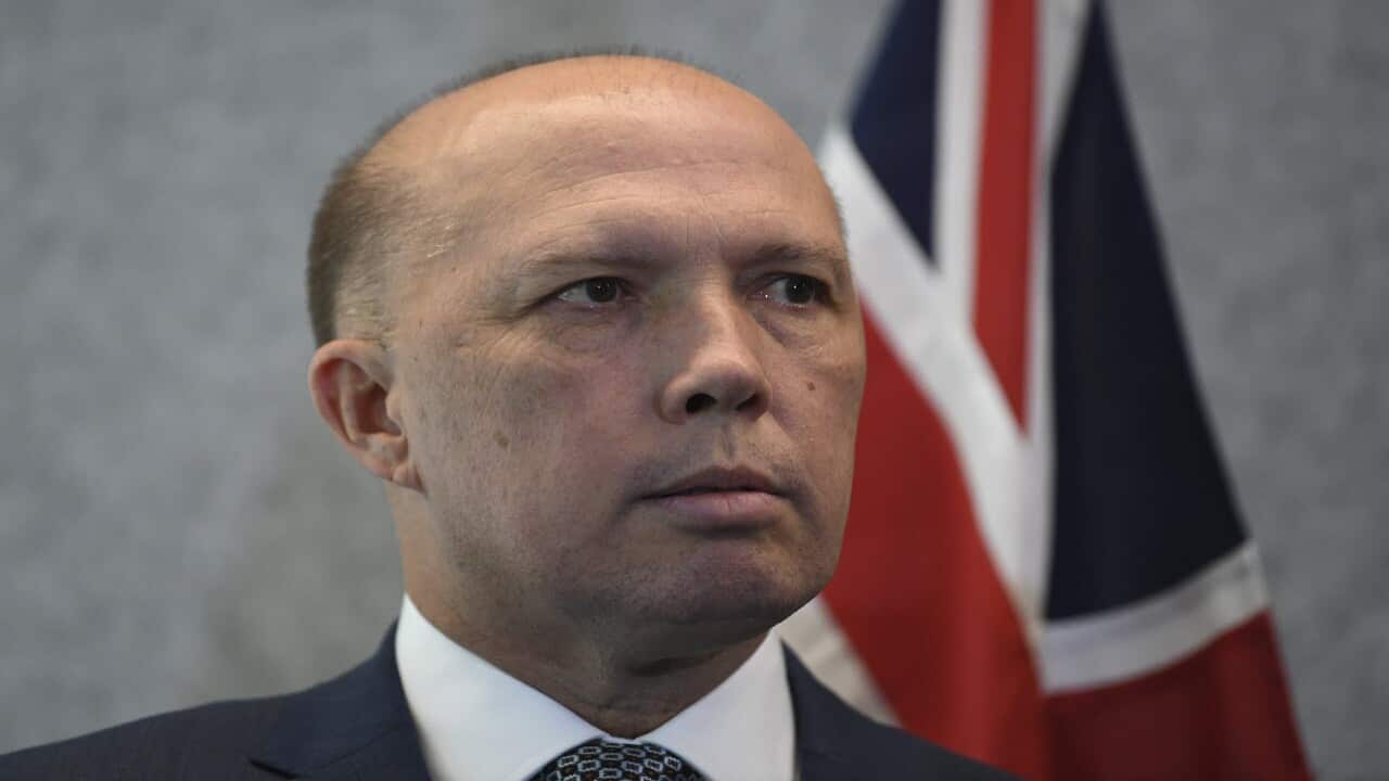 Australian Home Affairs Minister Peter Dutton speaks to the media