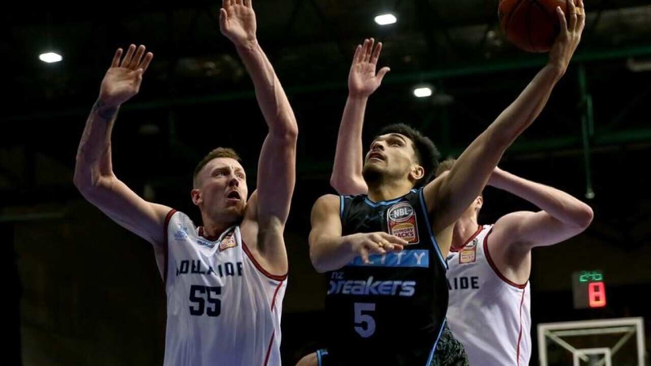Shea Ili of the Breakers beats Mitch Creek of the 36ers to score