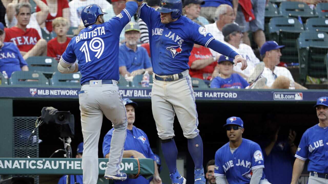 Toronto Blue Jays' Jose Bautista (19) and Josh Donaldson celebrate