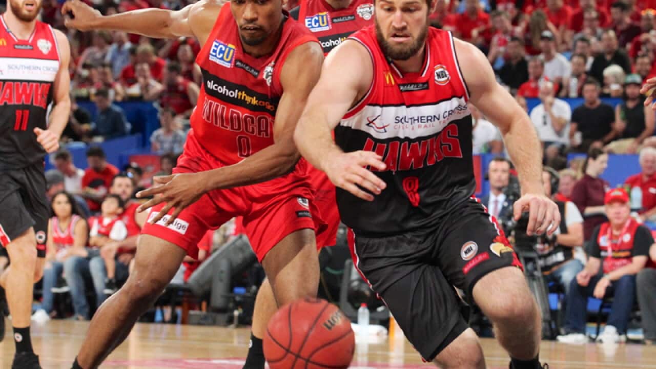 Bryce Cotton of the Wildcats (left) and Mitch Norton of the Hawks