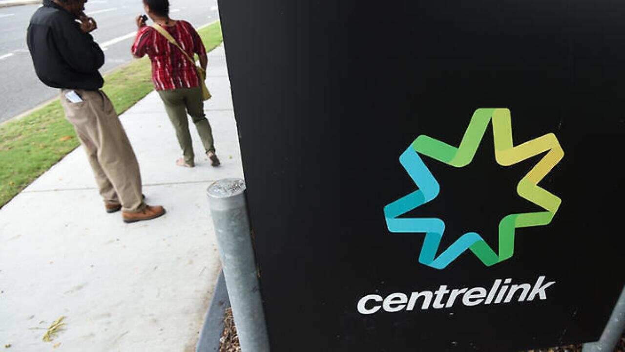 People stand outside a Centrelink office in Brisbane, Monday, March 21, 2016. Public Servants at Federal Governments department have begun striking nationwide after failed pay negotiations. (AAP Image/Dan Peled) NO ARCHIVING