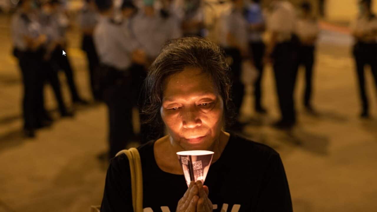 A woman holds a candle on the eve of the Beijing Tiananmen Massacre anniversary in Hong Kong