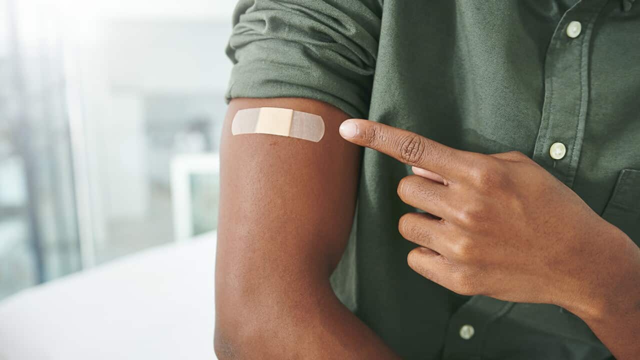 Shot of an unrecognizable person's arm with a band-aid