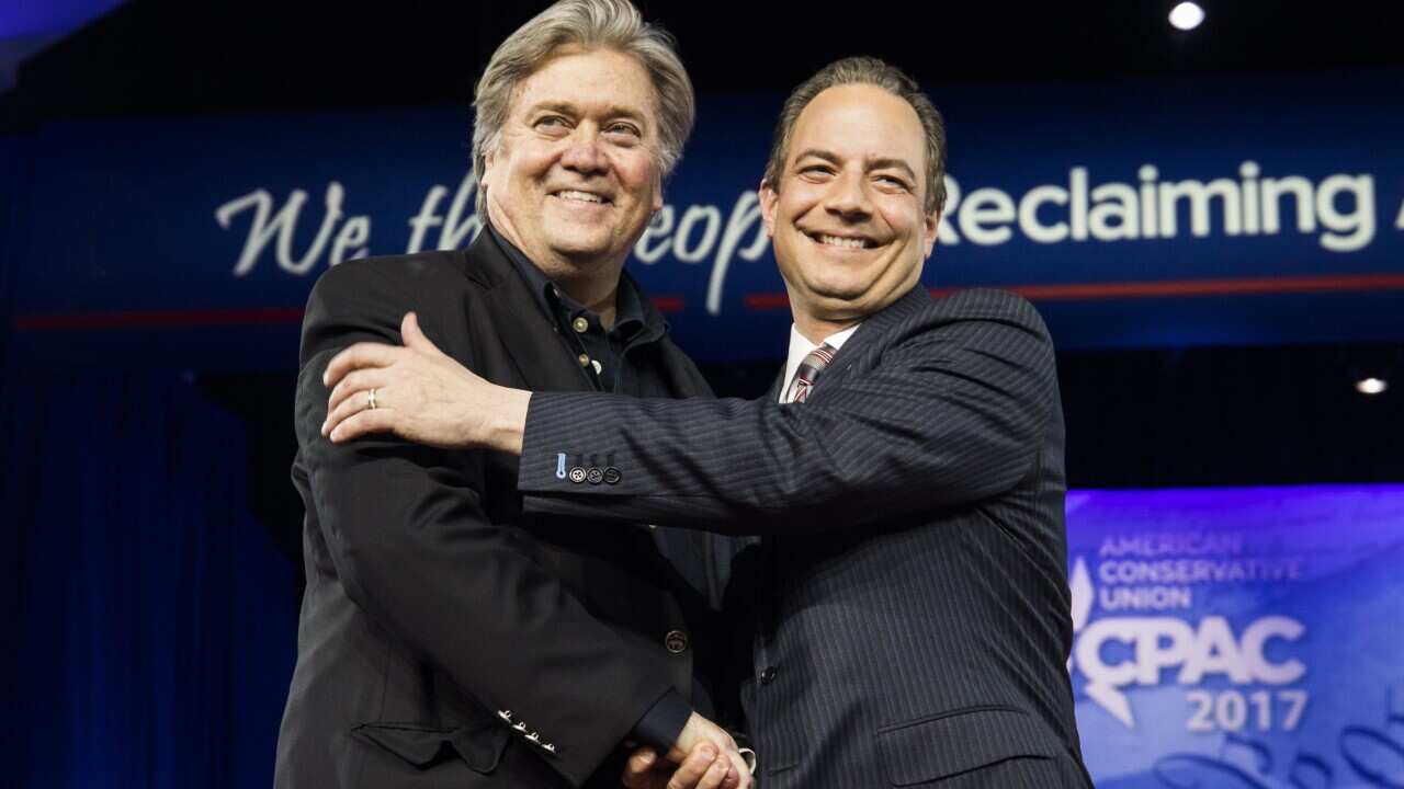 White House Chief Strategist Steve Bannon (L) and White House Chief of Staff Reince Priebus (R) shake hands
