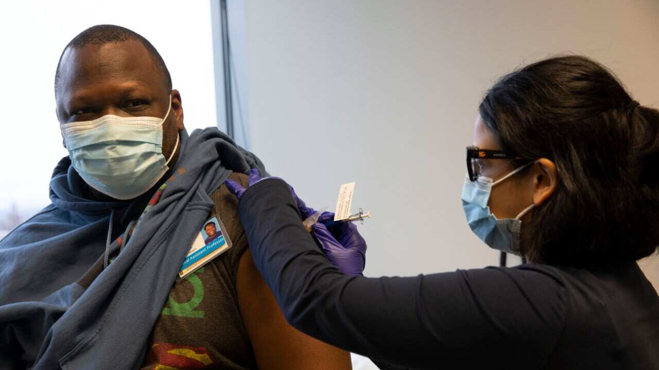 Dr Stephaun Wallace receives his second injection during the Novavax COVID-19 vaccine phase 3 clinical trials in Seattle, Washington on 12 February, 2021.