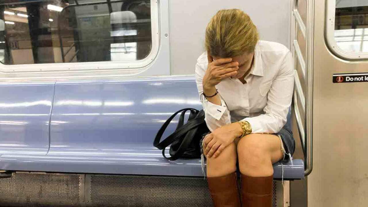 Stressed professional woman sitting on a train