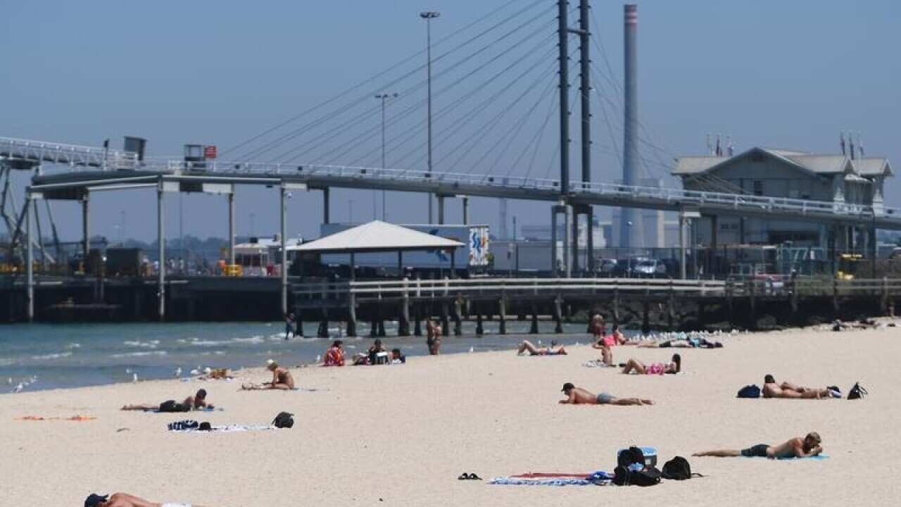 Beachgoers are seen at Port Melbourne beach in Melbourne.