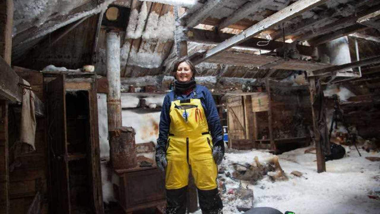 Mawson's Huts Foundation conservator Michelle Berry of Hobart stands inside the living section of Mawson's Hut at Cape Denison, Antarctica on December 11, 2015. Michelle Berry is part of an expedition visiting the site this summer to carry out vital conse