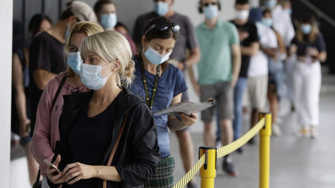 People wait in a line at a COVID-19 testing station on the northern beaches in Sydney