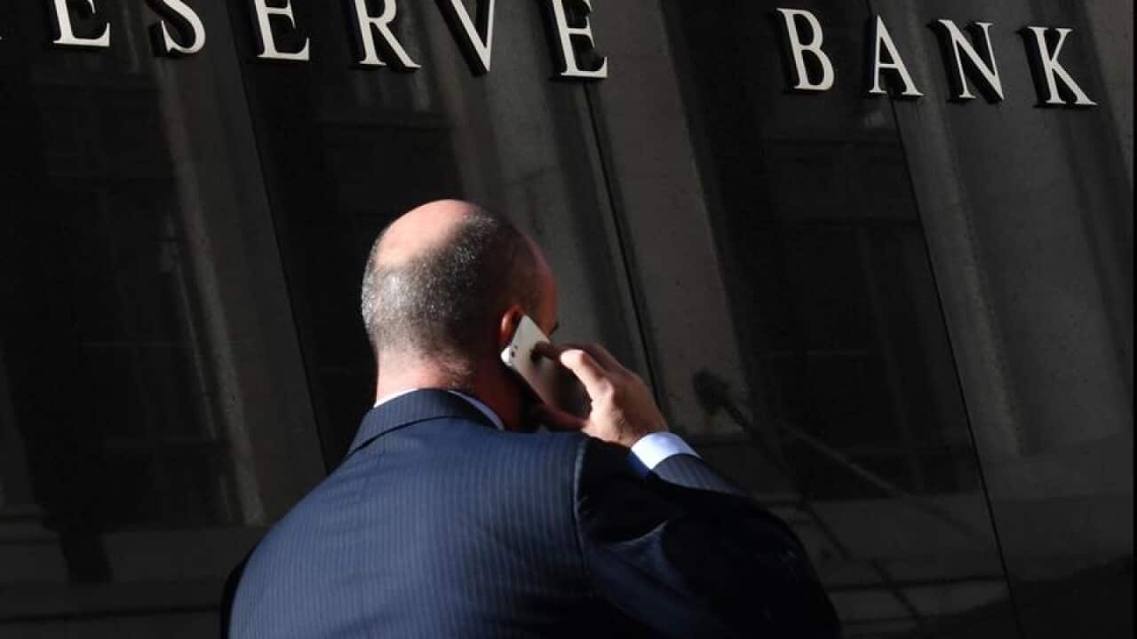 A pedestrian walks past the Reserve Bank of Australia