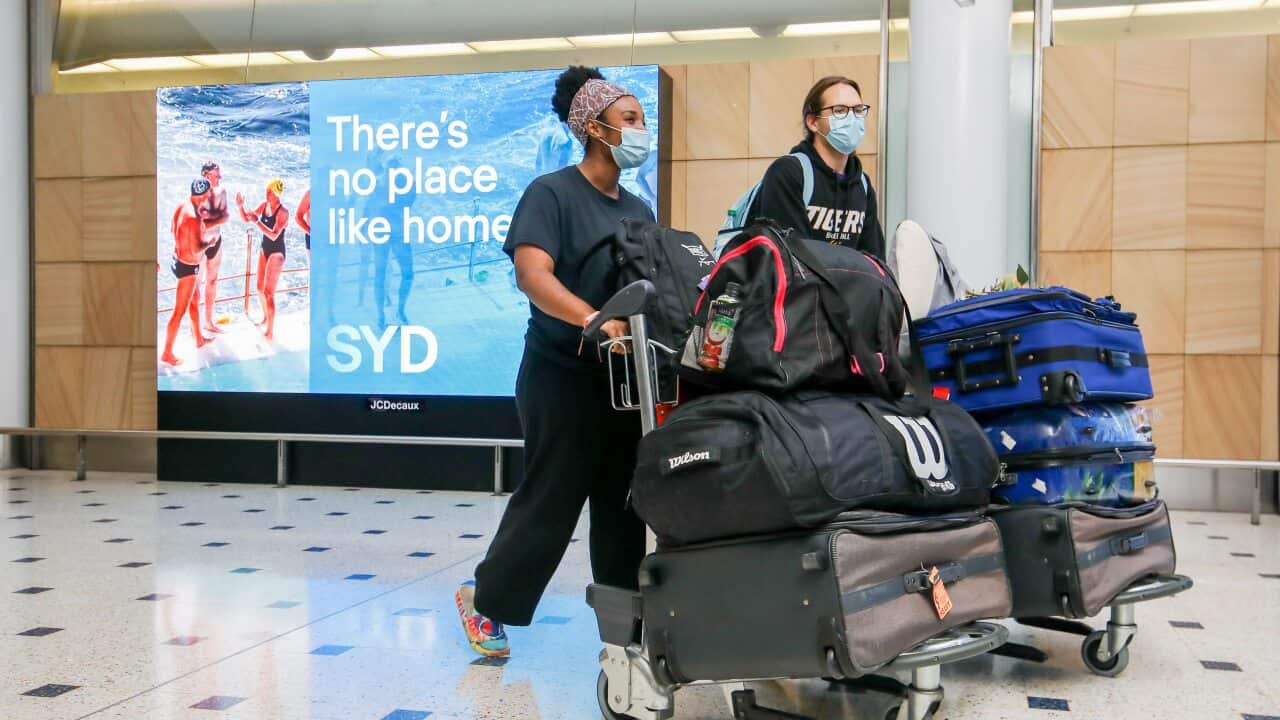 Passengers arrive from their flights and walk to the arrivals hall after landing at Sydney Airport