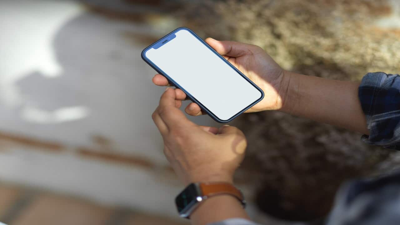 Midsection Of Man Using Mobile Phone