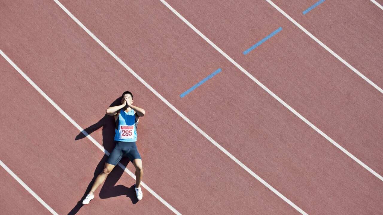 Tired runner laying on track