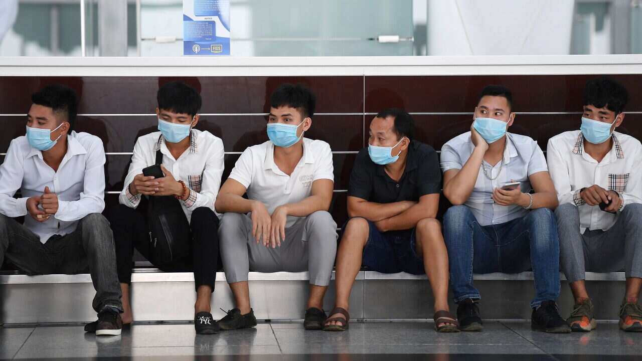 People wait inside the departure terminal at Noi Bai International Airport in Hanoi on 16 September, 2020