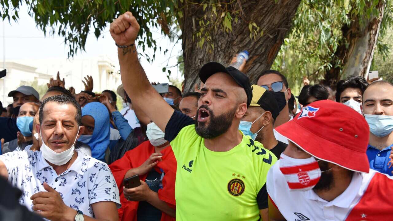A supporter of Tunisia's President Kais Saied, chants slogans denouncing the country's main Islamist Ennahda party during a demonstration outside parliament