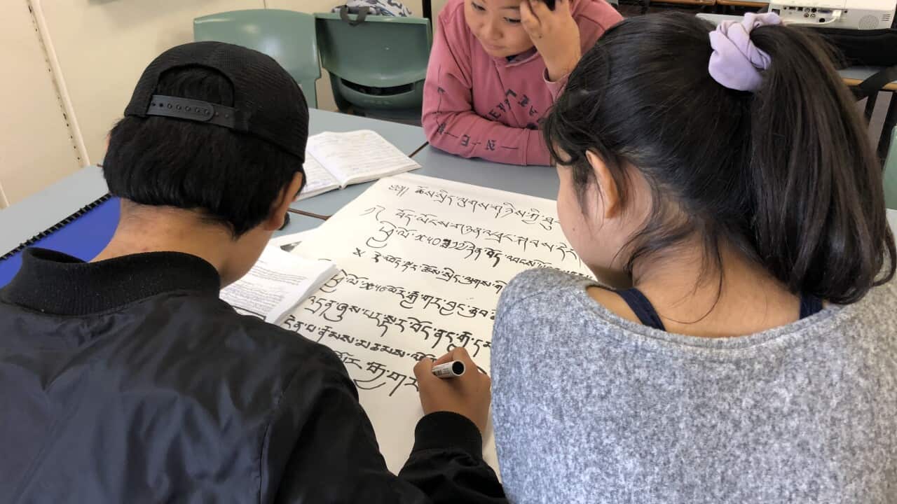 Kids writing Tibetan script