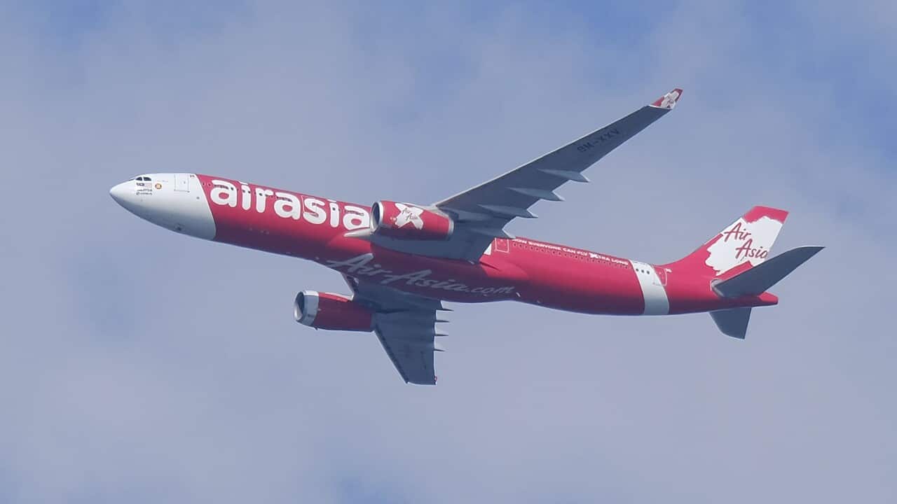 An AirAsia airplane seen flying in the sky at Kuala Lumpur