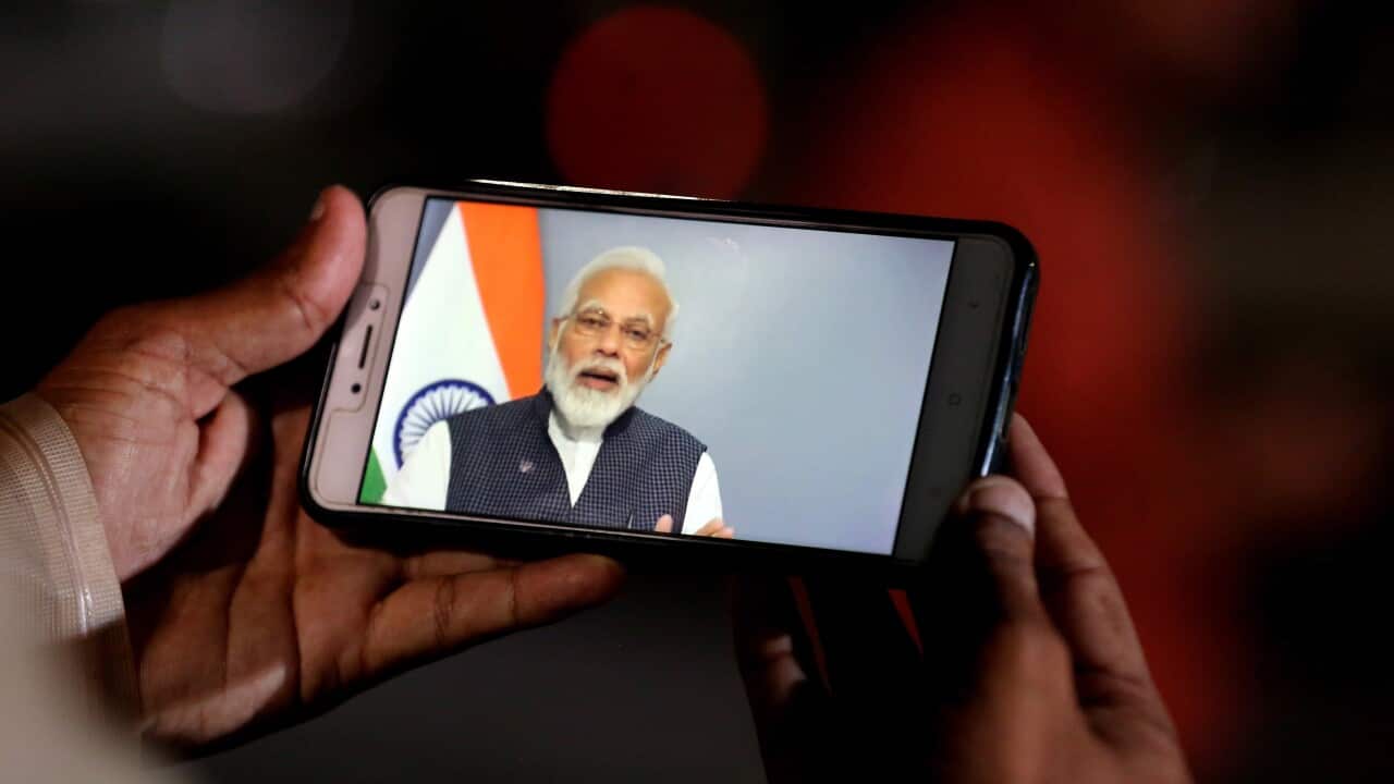 A person watches a live address by Indian Prime Minister Narendra Modi after the government scrap Article 370, in Bhopal, India.