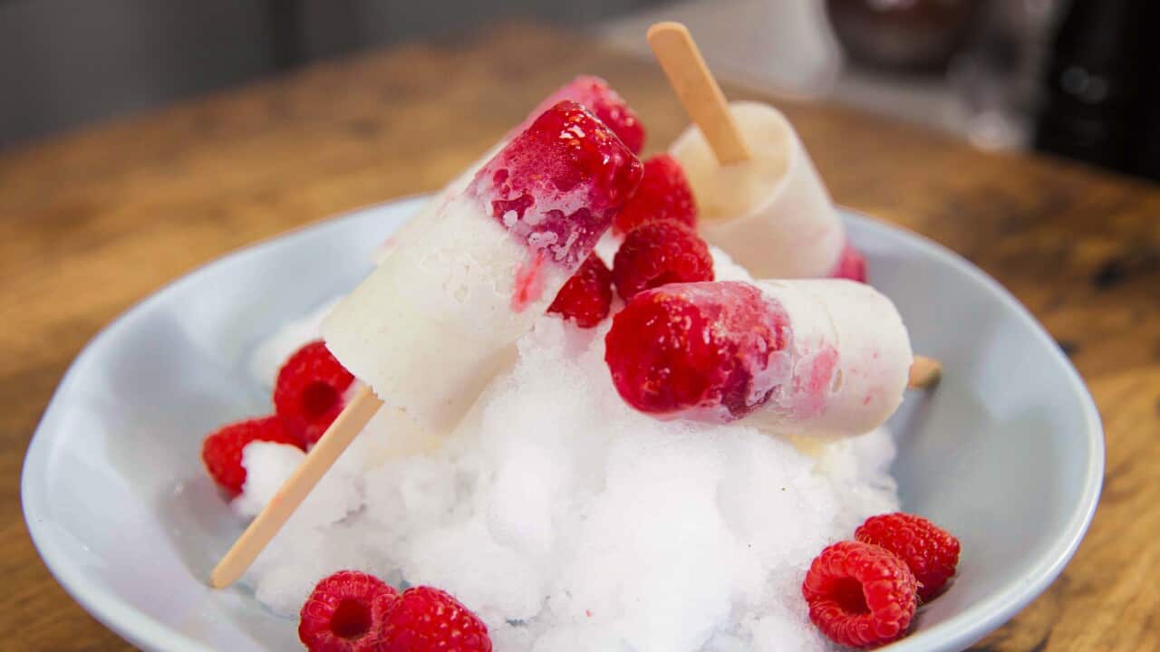 Four icypoles sit in a bowl of ice.