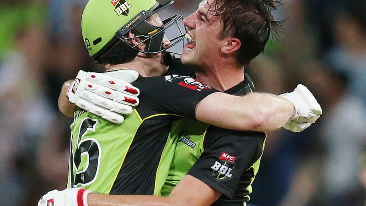 Eoin Morgan (L) of the Sydney Thunder celebrates with Pat Cummins