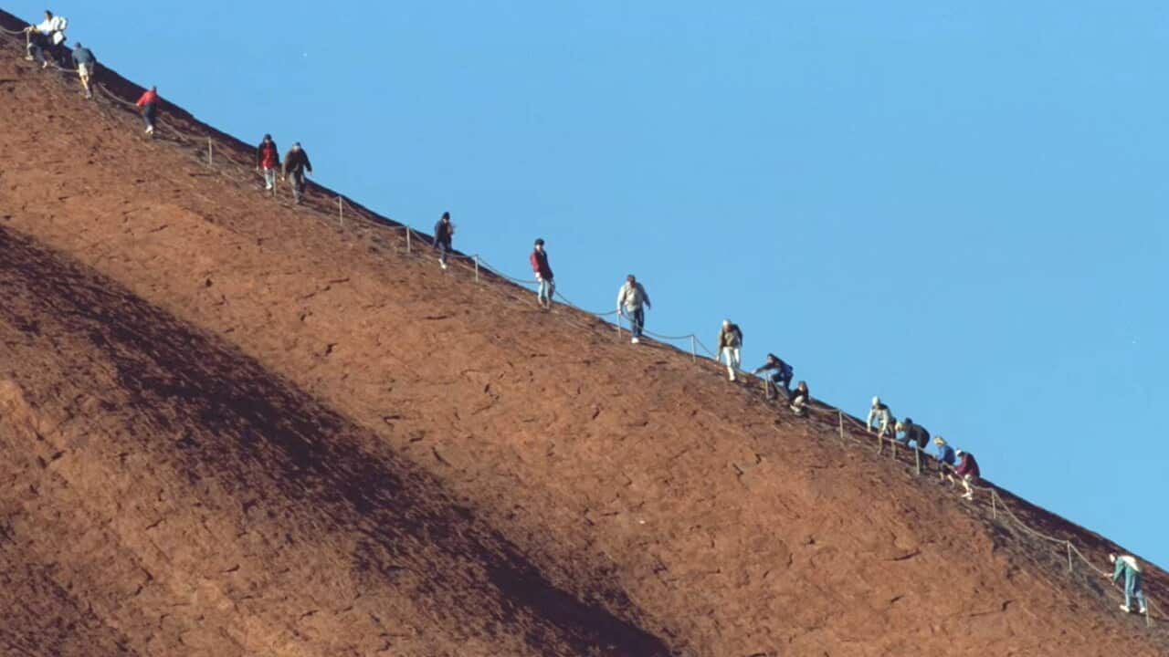 People climbing Uluru