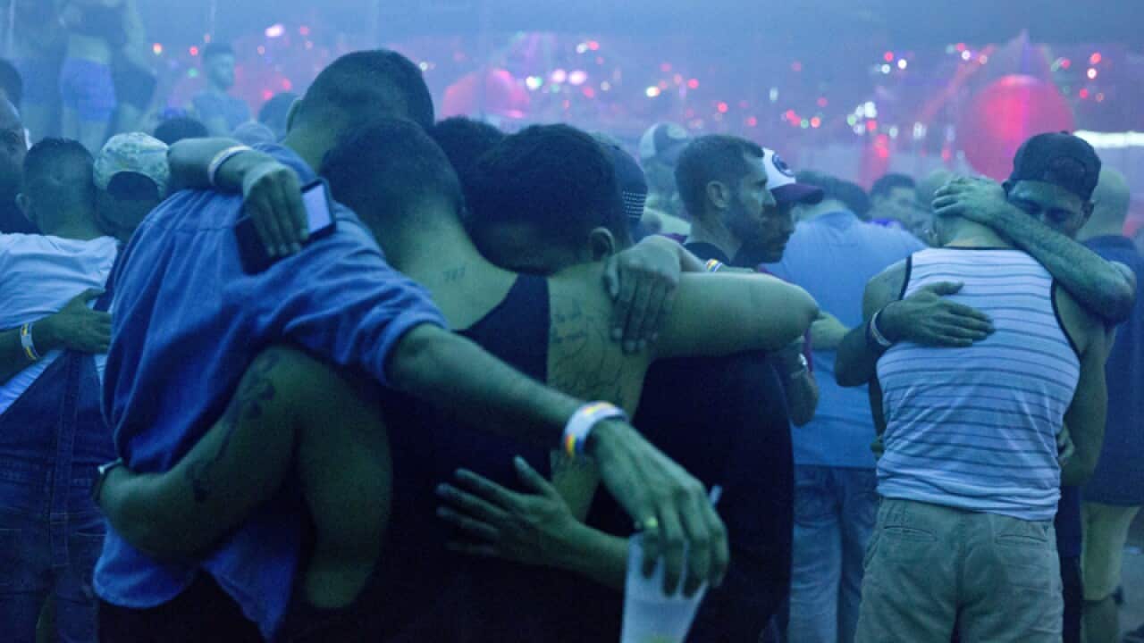 Clubgoers embrace to remember the Orlando nightclub victims