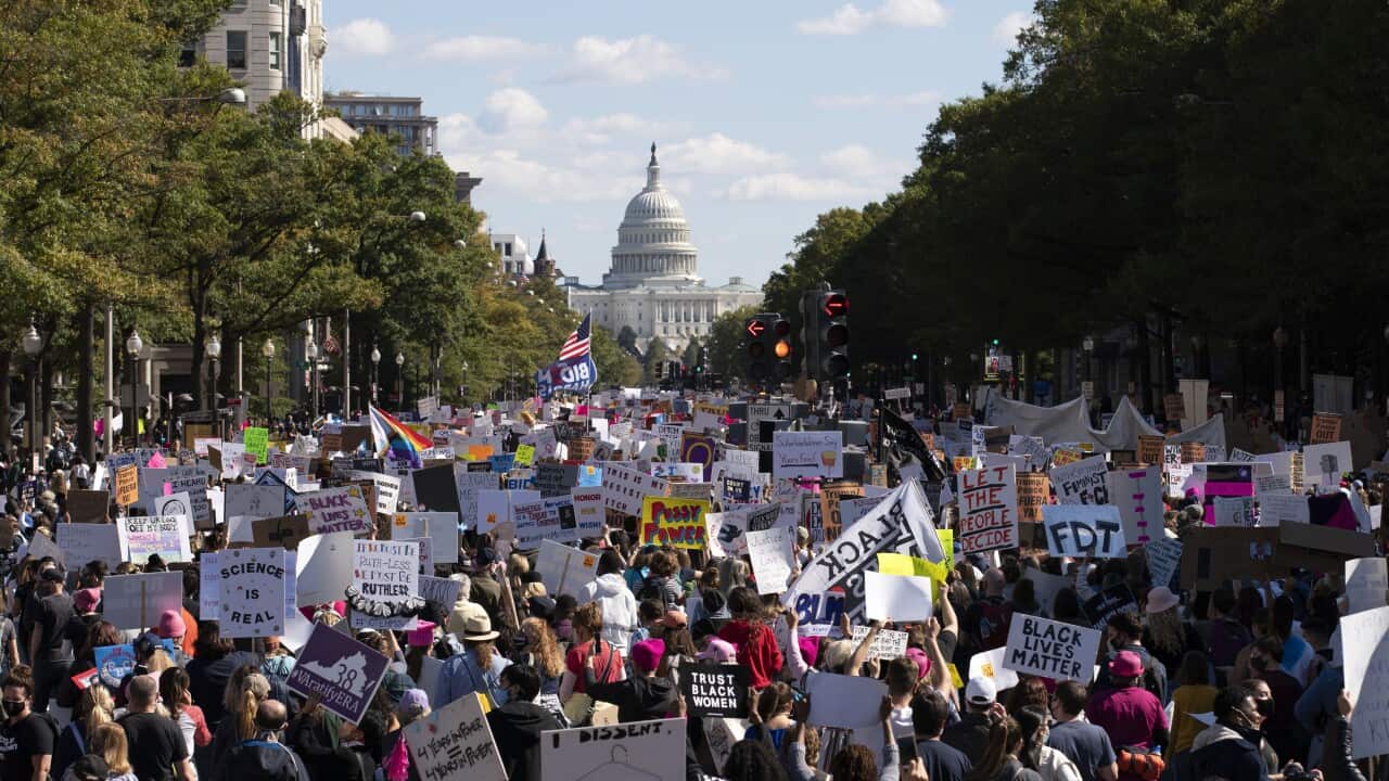 EDS NOTE: OBSCENITY - With the U.S Capitol in the back ground demonstrators march on Pennsylvania Avenue during the Women's March in Washington, Saturday, Oct. 17, 2020. (AP Photo/Jose Luis Magana)