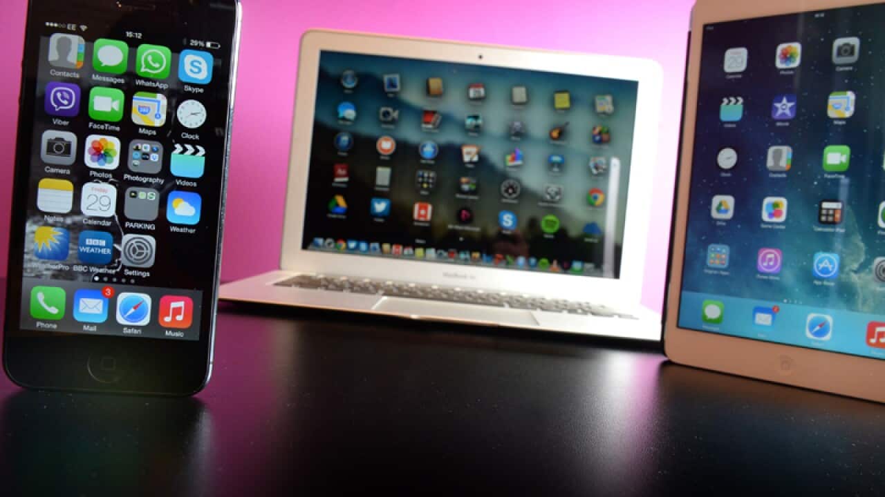 An Apple iPhone 5 (left), MacBook Air (centre) iPad Mini (right)