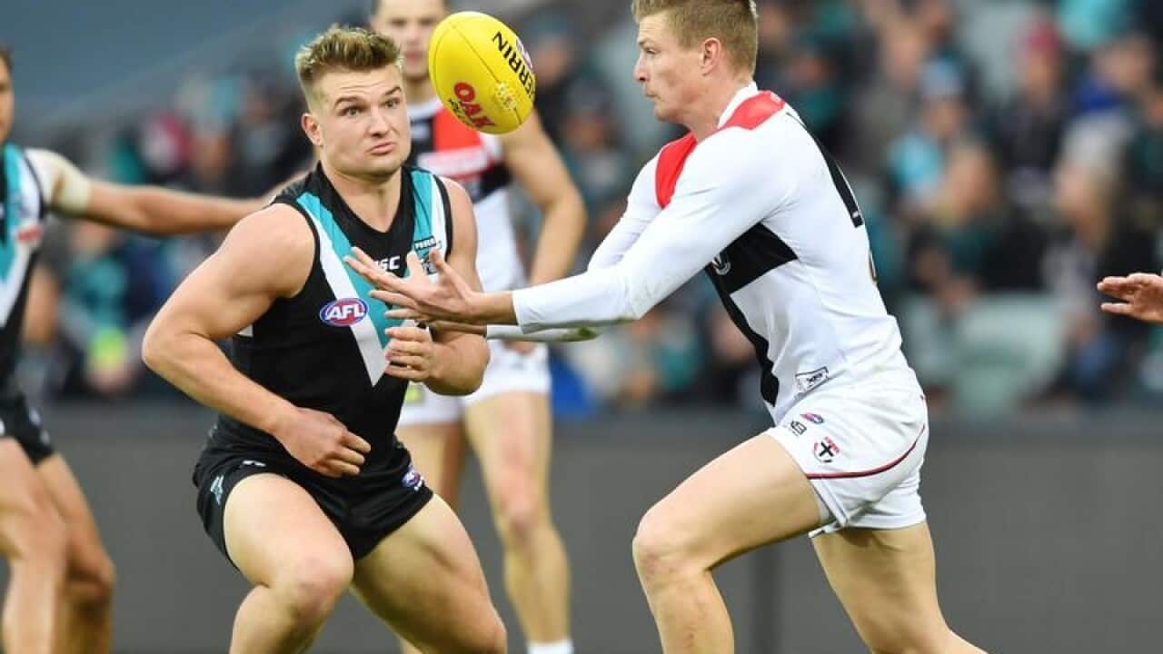 Jack Newnes of the Saints and Tom Rockliff of the Power contest.