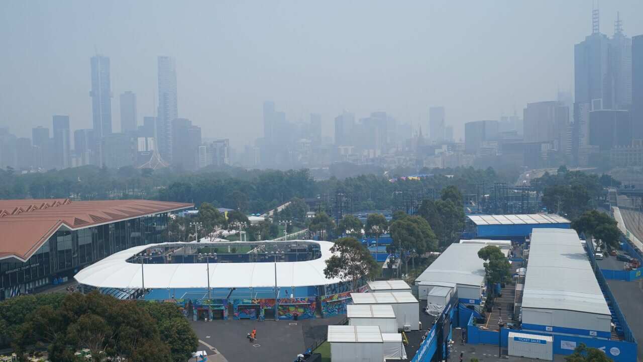 Melbourne's skyline is shielded by smoke haze during an Australian Open practice session at Melbourne Park.