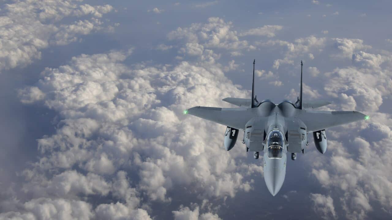 F-15 Figter Jet flying over clouds