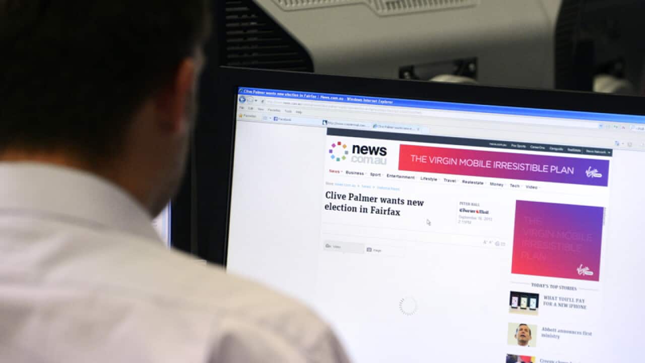 A man uses a desktop computer