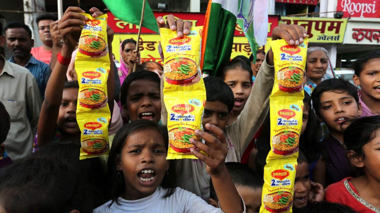 Indian children hold packets of Maggi brand noodles as they take part in a protest against their removal from shop shelves