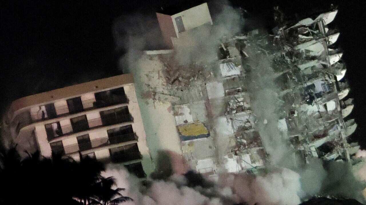 The remaining part of the partially collapsed Champlain Towers South condo building falls with a controlled demolition on 4 July, 2021 in Surfside, Florida.