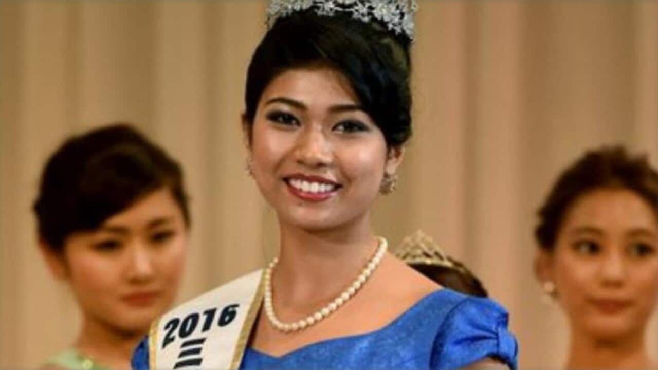 Priyanka Yoshikawa smiles as she holds the trophy after winning the Miss Japan title.
