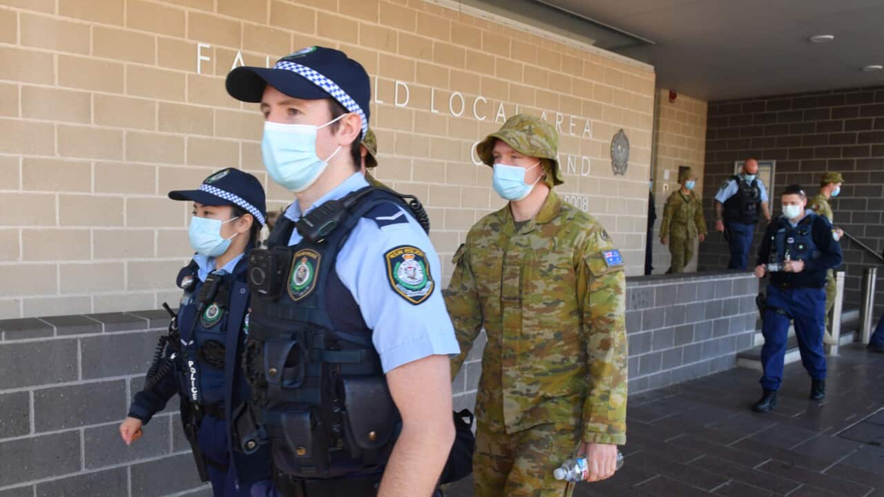 Australian Defence Force personnel and NSW Police are seen being deployed from Fairfield Police Station