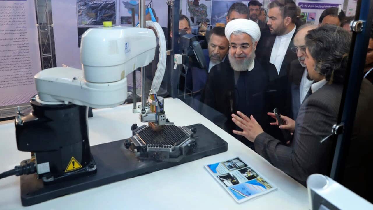 President Hassan Rouhani listens to explanations on some new nuclear achievements in the unveiling ceremony on "National Nuclear Day"
