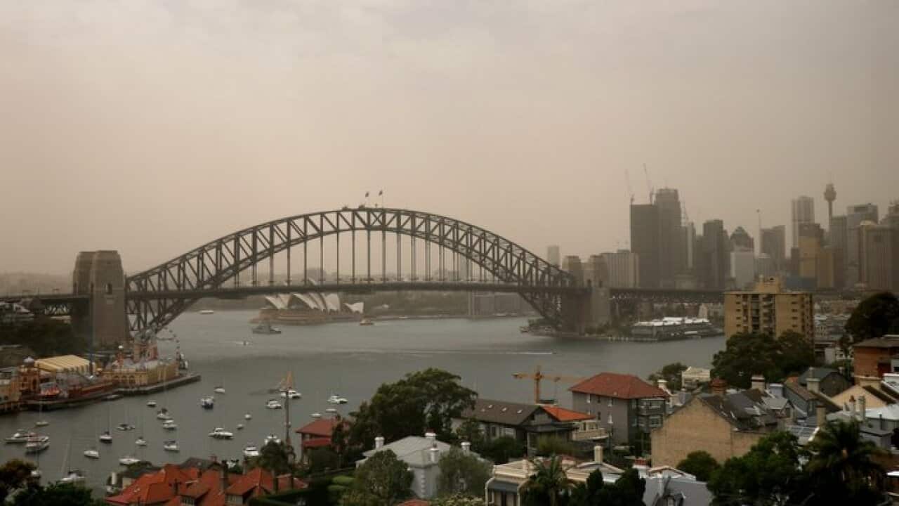 The Sydney Harbour Bridge is seen as a dust storm begins to roll into Sydney.